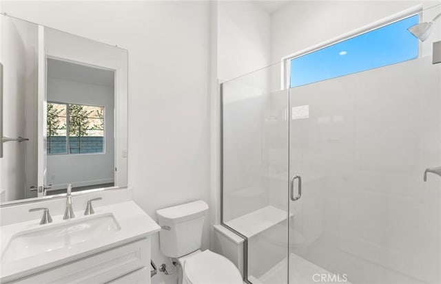 bathroom with vanity, toilet, and an enclosed shower