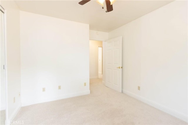 unfurnished room featuring light carpet and ceiling fan