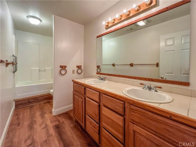 full bathroom featuring bathtub / shower combination, wood-type flooring, toilet, and vanity