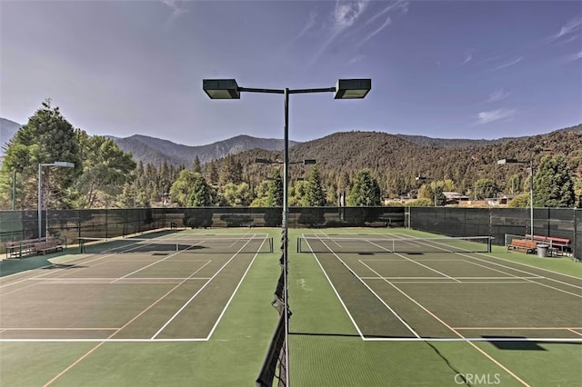 view of sport court with a mountain view and basketball court