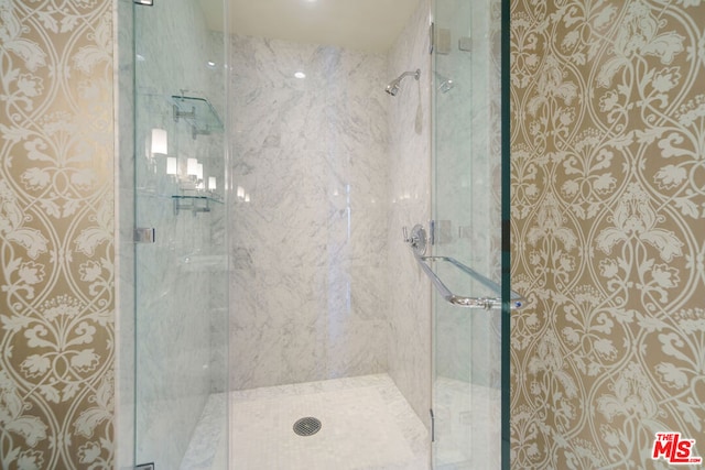 bathroom featuring a shower with shower door