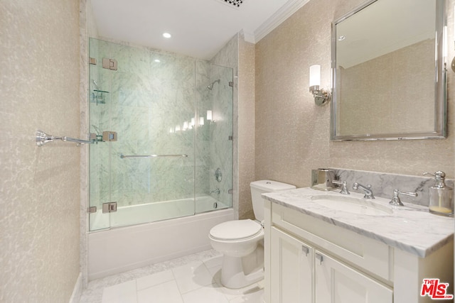 full bathroom featuring vanity, shower / bath combination with glass door, ornamental molding, toilet, and tile patterned floors