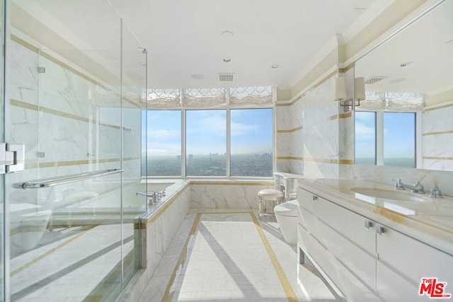 bathroom with ornamental molding, vanity, a healthy amount of sunlight, and separate shower and tub