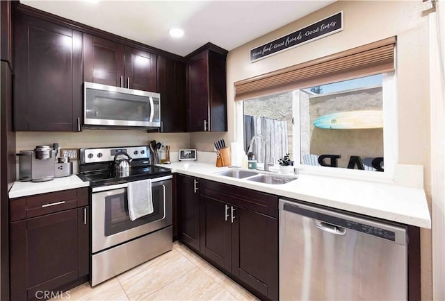 kitchen featuring dark brown cabinets, sink, and appliances with stainless steel finishes