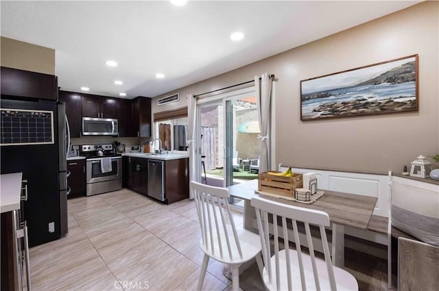 kitchen featuring dark brown cabinets, stainless steel appliances, and sink