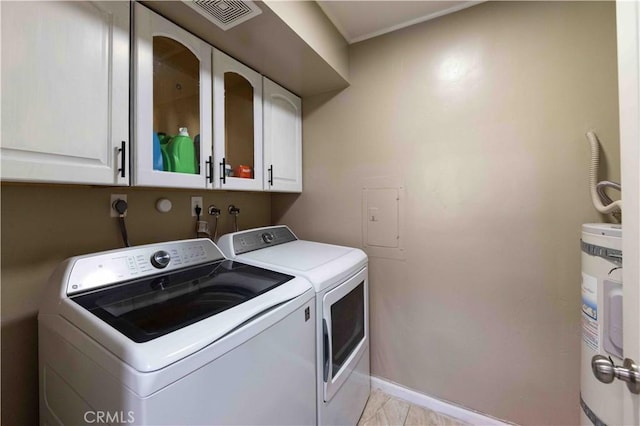 clothes washing area featuring washer and clothes dryer, cabinets, and secured water heater