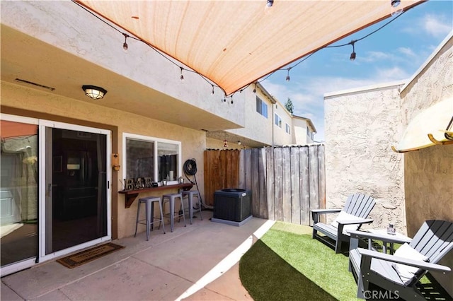 view of patio / terrace with an outdoor bar and central air condition unit