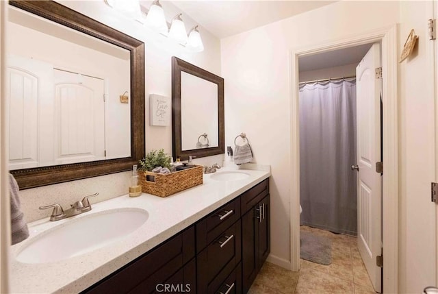 bathroom with tile patterned floors and vanity