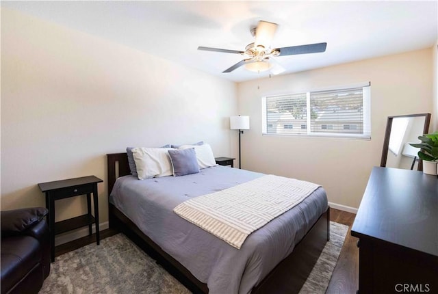 bedroom featuring ceiling fan and dark wood-type flooring