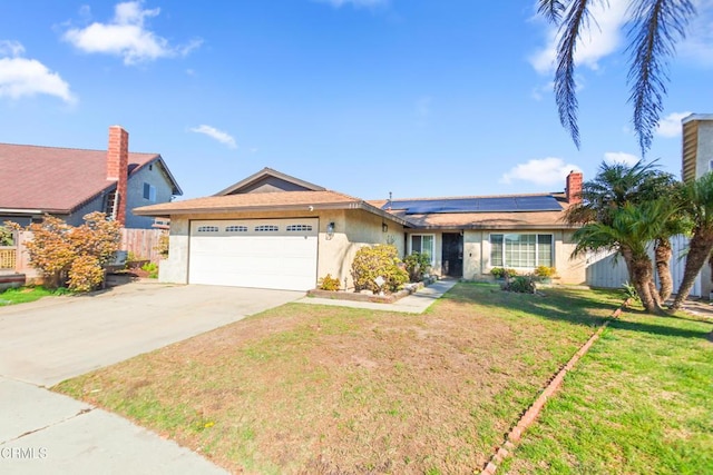 ranch-style house with a front yard, solar panels, and a garage