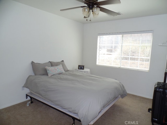 bedroom with ceiling fan and light carpet