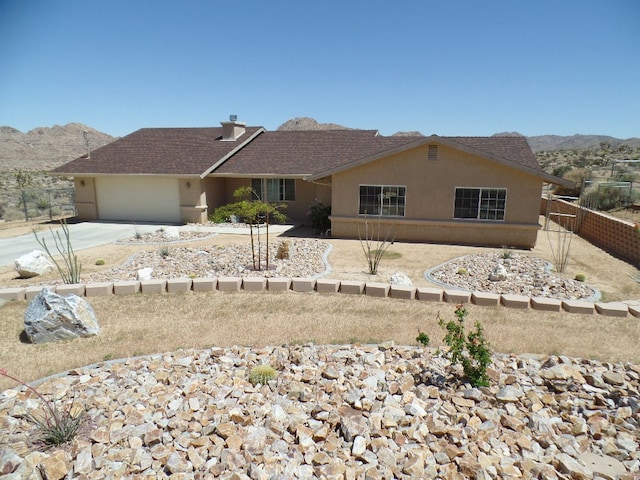 view of front of property featuring a mountain view and a garage