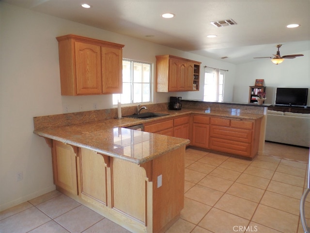 kitchen with kitchen peninsula, light tile patterned flooring, and ceiling fan