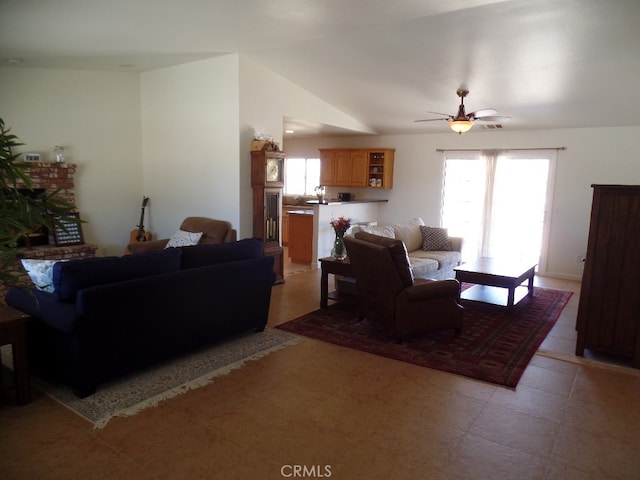 living room with lofted ceiling, ceiling fan, and plenty of natural light