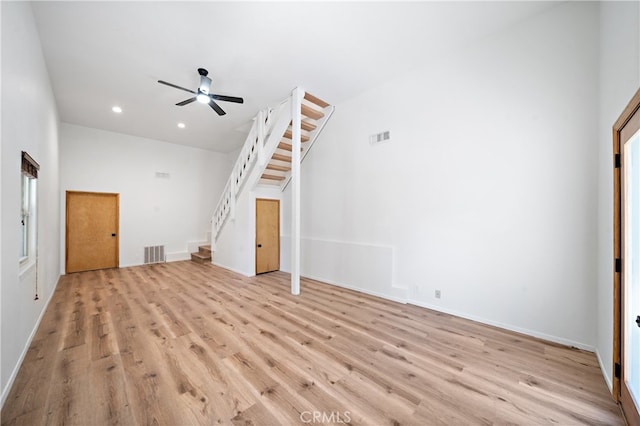 unfurnished living room with a healthy amount of sunlight, ceiling fan, and light hardwood / wood-style flooring