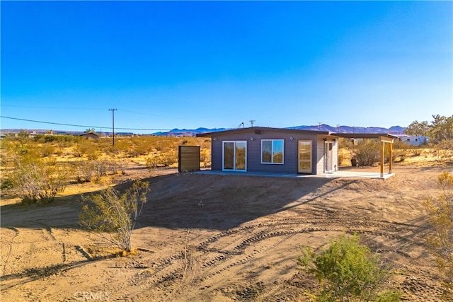 back of property with a mountain view