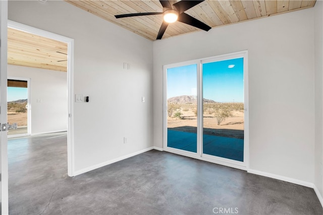 spare room featuring ceiling fan, a mountain view, wood ceiling, and a healthy amount of sunlight