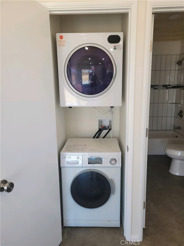 laundry room featuring stacked washer and clothes dryer