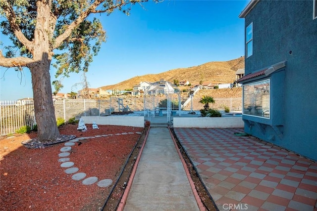 view of yard featuring a mountain view and a patio