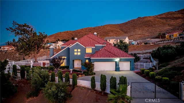 view of front of home with a garage and a mountain view