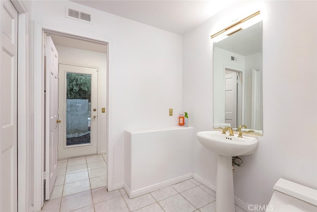 bathroom with sink, tile patterned floors, and toilet