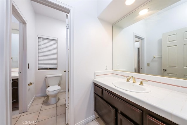 bathroom featuring tile patterned flooring, vanity, and toilet