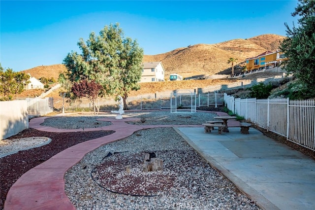 view of yard with a mountain view and a patio area