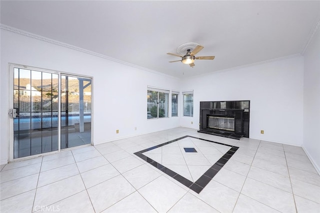 unfurnished living room featuring crown molding, a tile fireplace, and light tile patterned floors