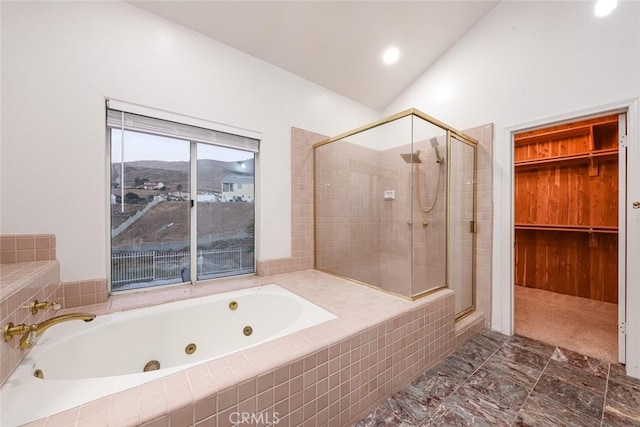 bathroom featuring lofted ceiling, plus walk in shower, and a mountain view