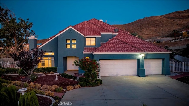 view of front of house featuring a garage and a mountain view