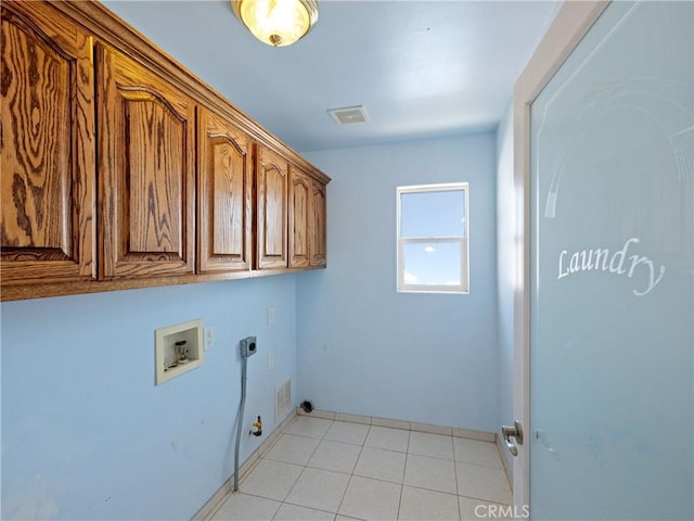 washroom with hookup for a gas dryer, light tile patterned flooring, washer hookup, hookup for an electric dryer, and cabinets