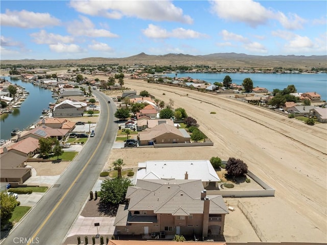 drone / aerial view with a water and mountain view