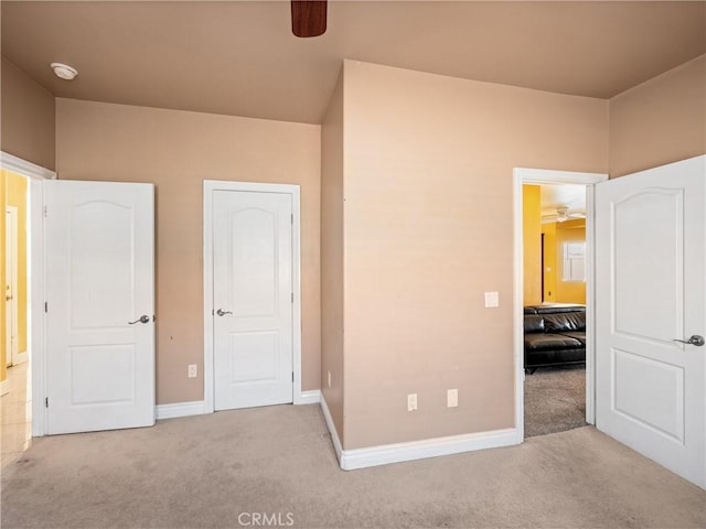 unfurnished bedroom with light carpet and ceiling fan