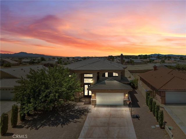 prairie-style house featuring a garage and a mountain view