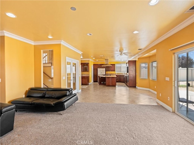 tiled living room with ceiling fan and crown molding