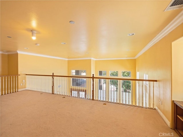 spare room with crown molding and carpet floors