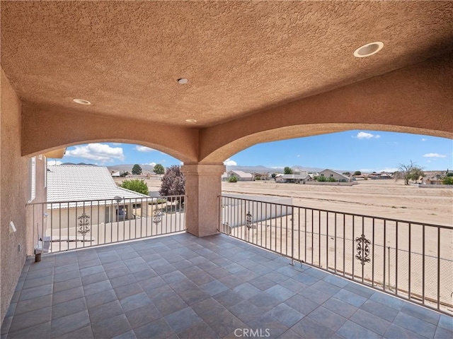 view of patio featuring a balcony