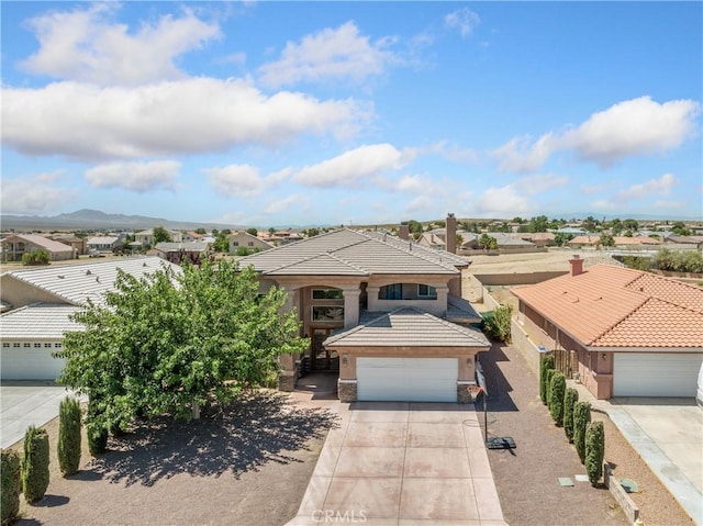 view of front of house with a mountain view and a garage