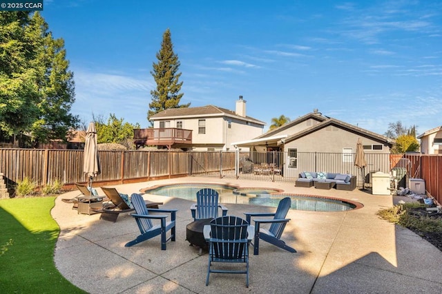 view of swimming pool featuring a patio, an in ground hot tub, and an outdoor living space