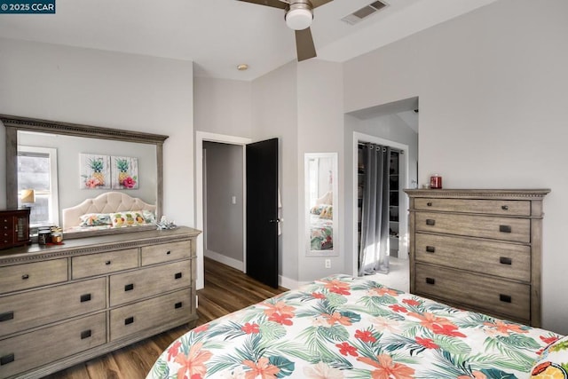 bedroom with dark wood-type flooring, ceiling fan, and a closet