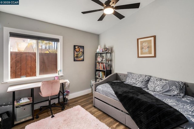 bedroom with ceiling fan, dark wood-type flooring, and lofted ceiling