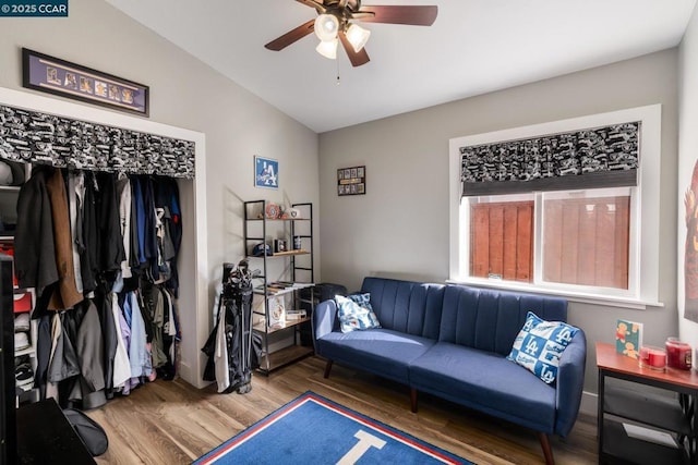 living area with lofted ceiling, ceiling fan, and hardwood / wood-style floors