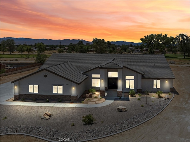 view of front of home featuring a patio and a mountain view