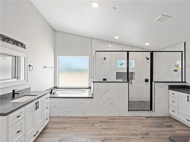 bathroom with vanity, lofted ceiling, shower with separate bathtub, and hardwood / wood-style floors