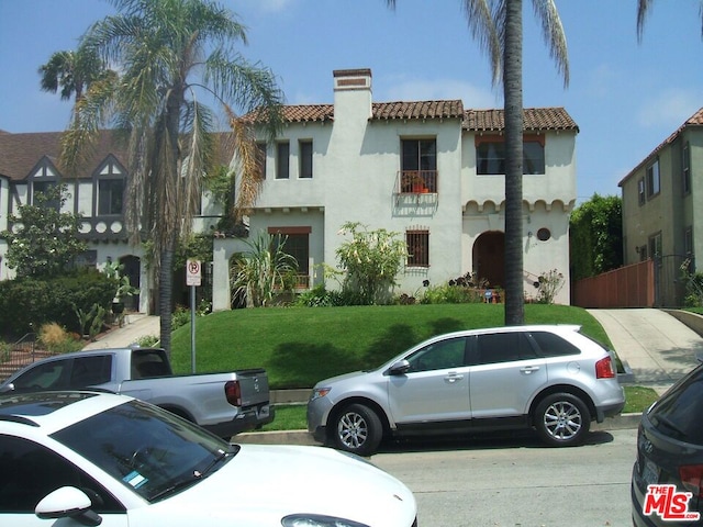 mediterranean / spanish house with a front yard