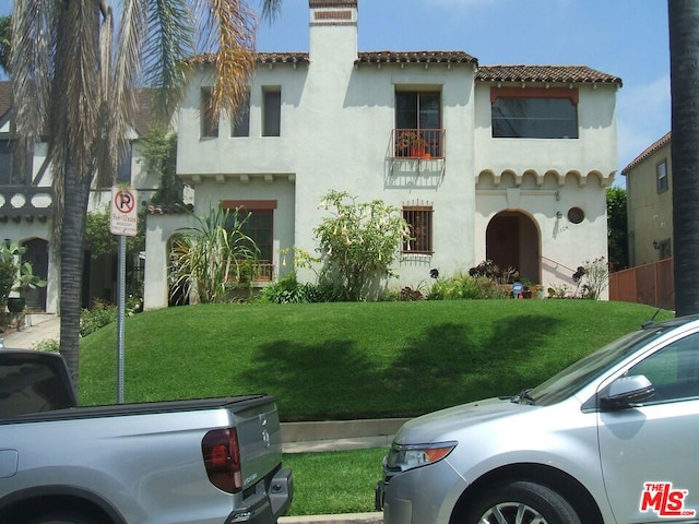 mediterranean / spanish-style house with a front lawn