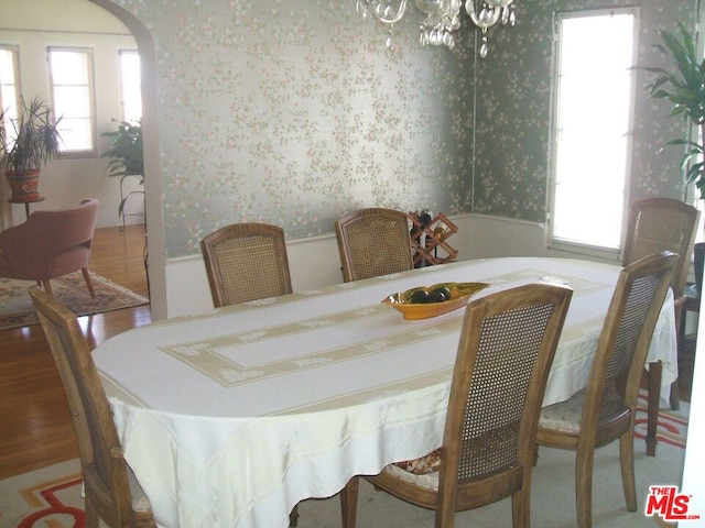 dining space featuring an inviting chandelier and hardwood / wood-style flooring