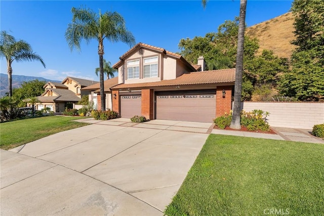 view of front of property with a mountain view and a front yard