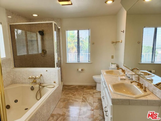 full bathroom with a healthy amount of sunlight, vanity, plus walk in shower, and toilet