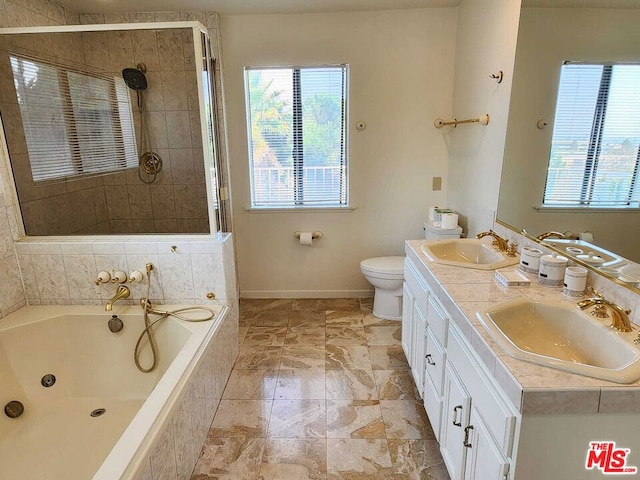 full bathroom with a wealth of natural light, separate shower and tub, vanity, and toilet